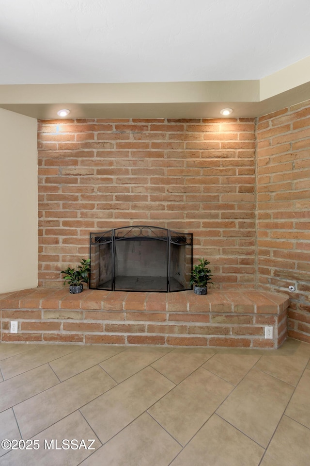 interior details featuring a brick fireplace