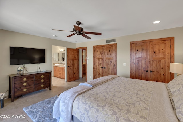 bedroom with visible vents, light tile patterned flooring, ensuite bathroom, ceiling fan, and recessed lighting