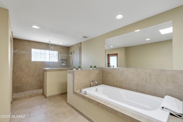 bathroom with walk in shower, a garden tub, recessed lighting, and visible vents