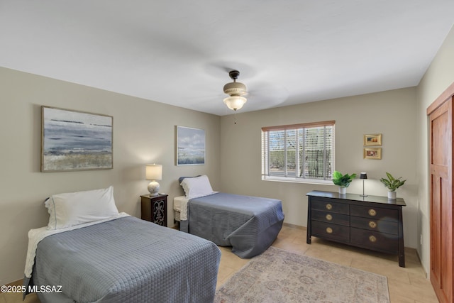 bedroom with baseboards, ceiling fan, and light tile patterned flooring