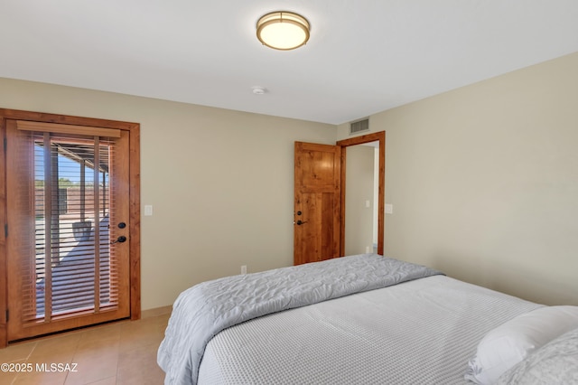 bedroom featuring baseboards, access to outside, light tile patterned flooring, and visible vents