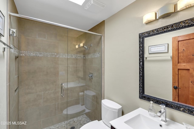 full bathroom with vanity, toilet, visible vents, and a stall shower