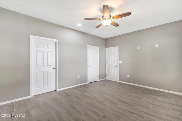 3000 S Smokin Pistol Way, Tucson, AZ 85713 - unfurnished bedroom with baseboards, wood finished floors, recessed lighting, and ceiling fan