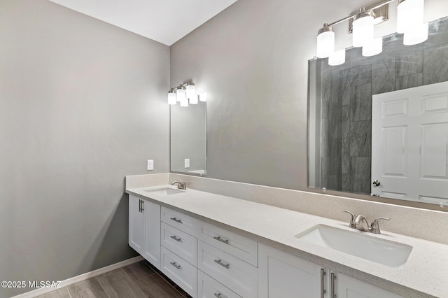3000 S Smokin Pistol Way, Tucson, AZ 85713 - bathroom with double vanity, baseboards, wood finished floors, and a tile shower