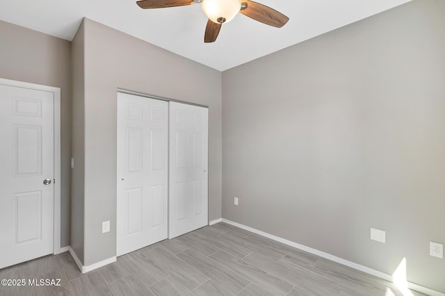 3000 S Smokin Pistol Way, Tucson, AZ 85713 - unfurnished bedroom with a closet, baseboards, light wood-type flooring, and a ceiling fan