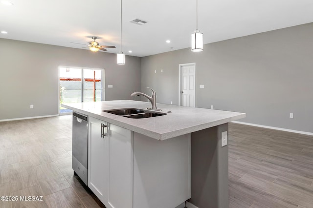 3000 S Smokin Pistol Way, Tucson, AZ 85713 - kitchen with a sink, dishwasher, an island with sink, ceiling fan, and light wood-style flooring