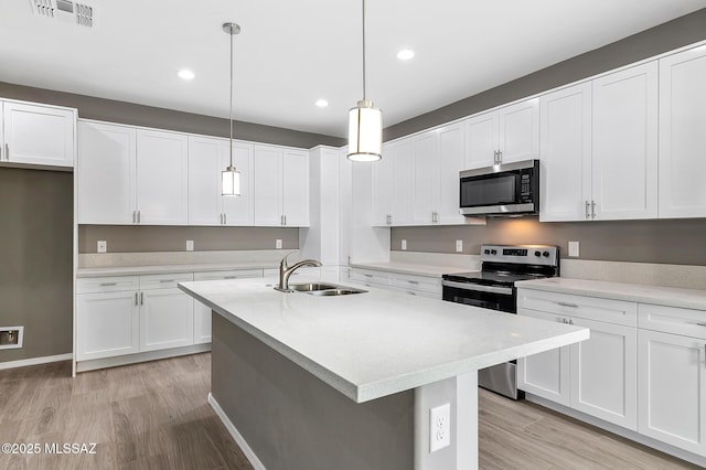 3000 S Smokin Pistol Way, Tucson, AZ 85713 - kitchen featuring stainless steel appliances, a sink, light wood finished floors, light countertops, and recessed lighting