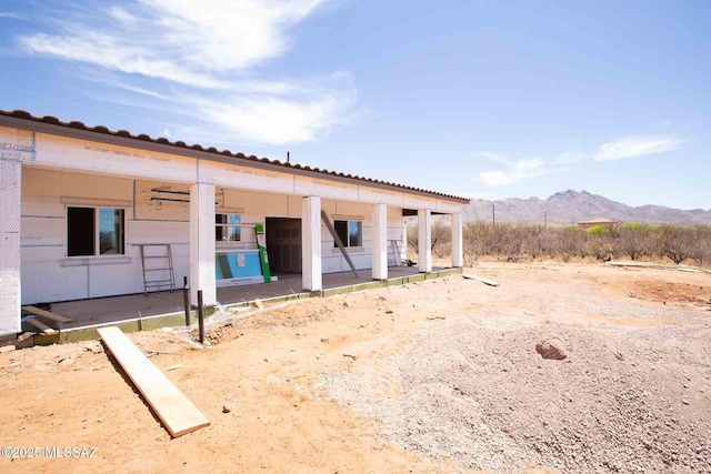 rear view of property featuring a mountain view