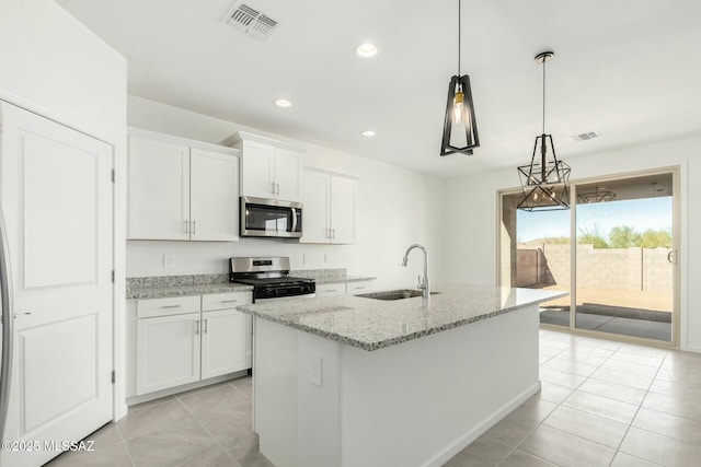 kitchen with light tile patterned floors, appliances with stainless steel finishes, white cabinets, a sink, and visible vents