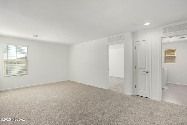 carpeted spare room with recessed lighting, visible vents, and baseboards