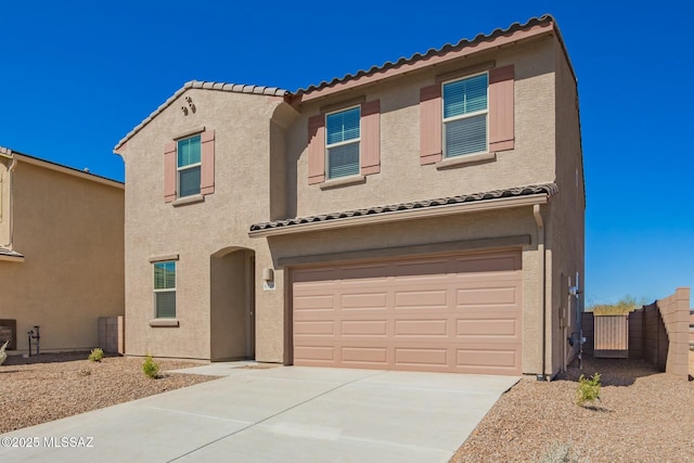 view of front facade featuring a garage, concrete driveway, stucco siding, and a tiled roof