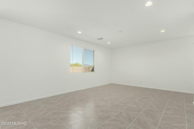 spare room with visible vents, recessed lighting, and baseboards
