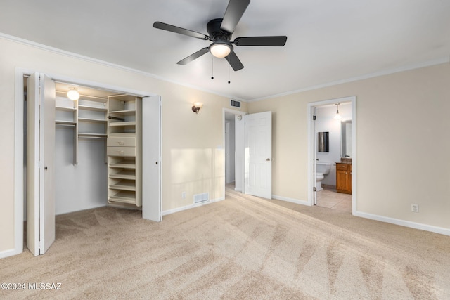 unfurnished bedroom featuring ornamental molding, light carpet, ensuite bathroom, baseboards, and a closet
