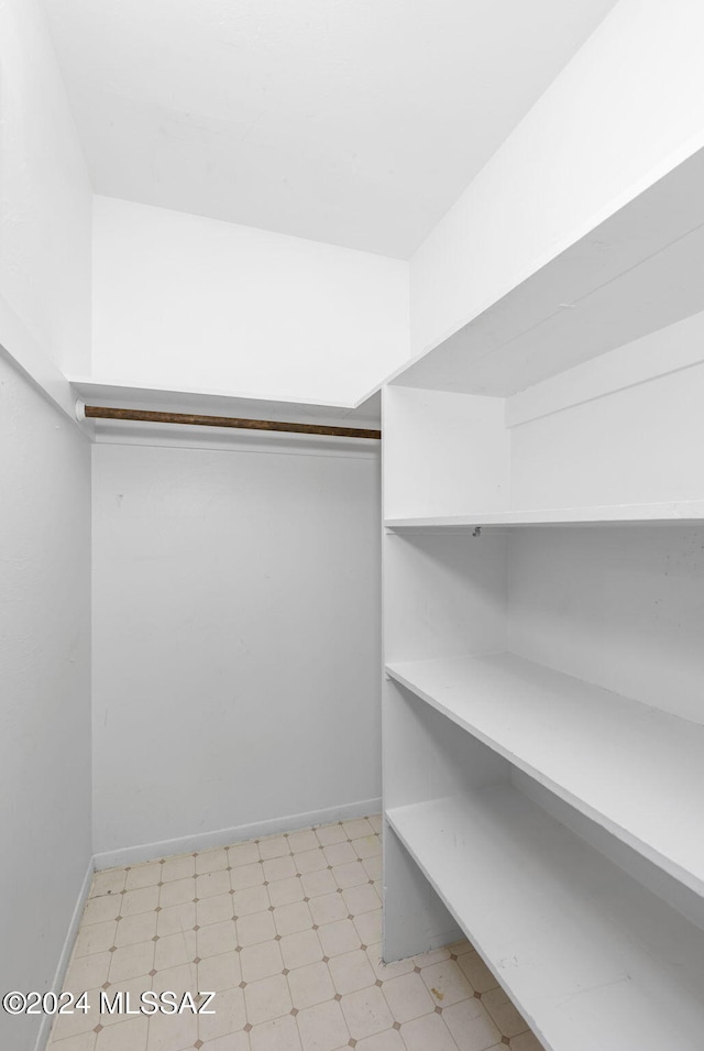 walk in closet featuring light floors