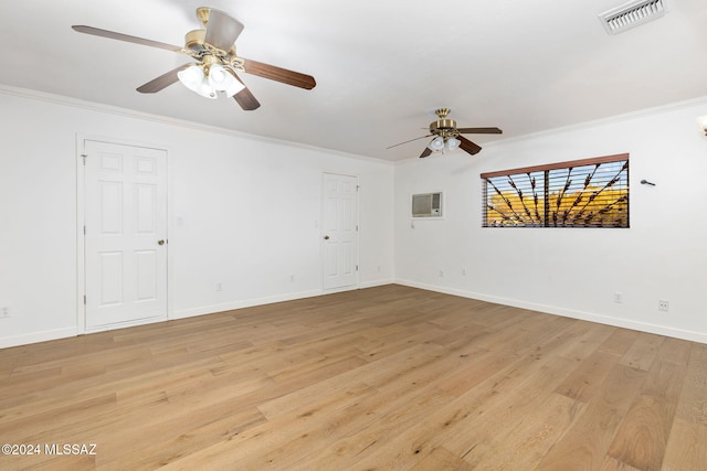 empty room with a ceiling fan, light wood finished floors, ornamental molding, and baseboards