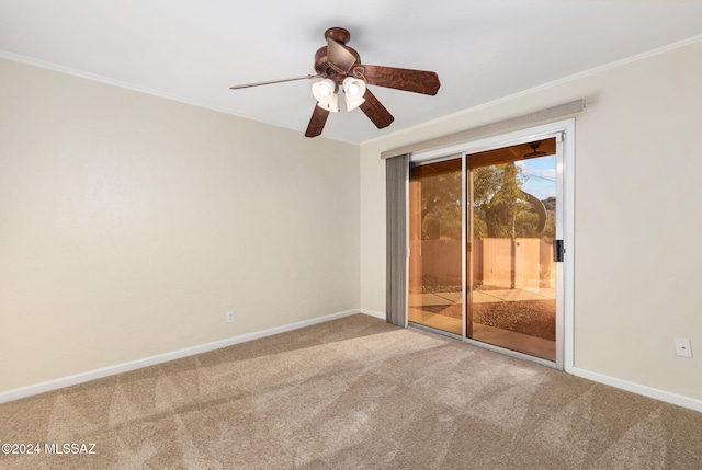 carpeted spare room featuring ceiling fan, baseboards, and ornamental molding