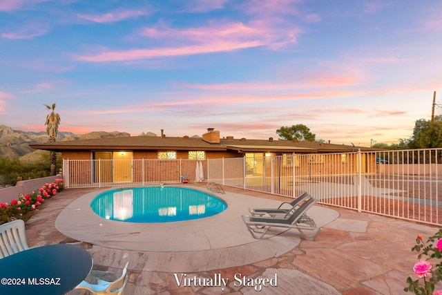 view of swimming pool featuring fence and a patio area