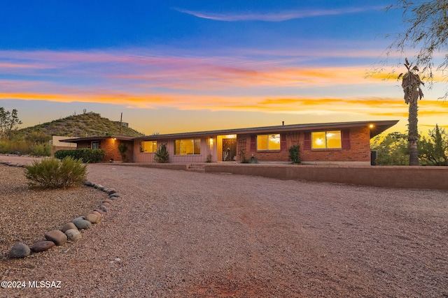 ranch-style home featuring brick siding