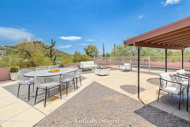 view of patio / terrace with an outdoor hangout area and fence
