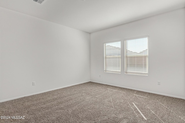 empty room with baseboards and carpet floors