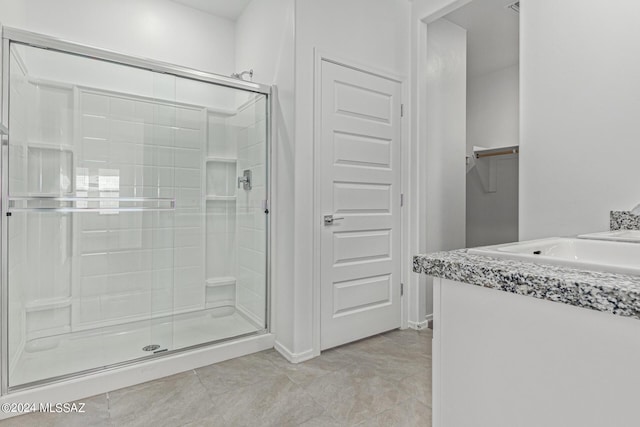 full bath with a stall shower, tile patterned flooring, and a closet