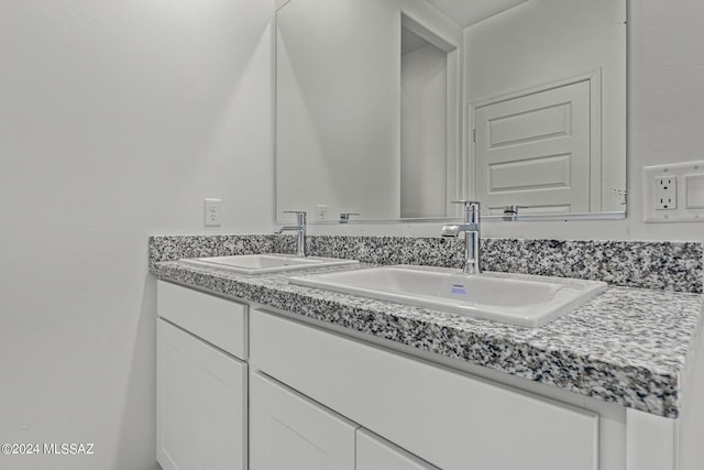 bathroom with double vanity and a sink