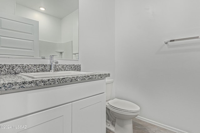 bathroom with recessed lighting, tile patterned flooring, toilet, vanity, and baseboards