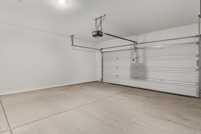 garage with a garage door opener and baseboards