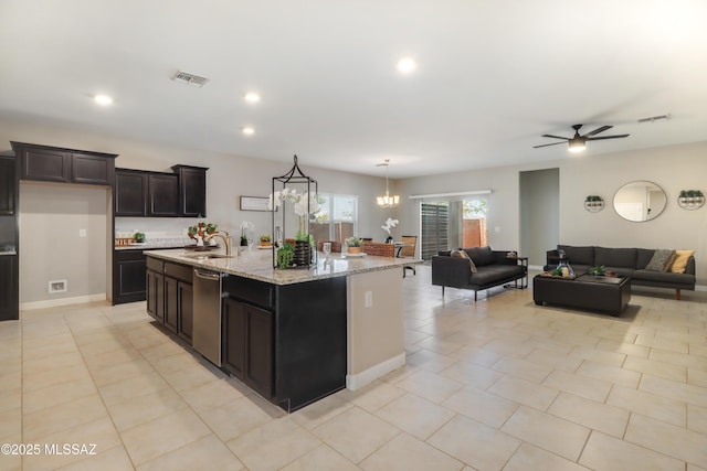 kitchen featuring visible vents, open floor plan, dishwasher, and a sink