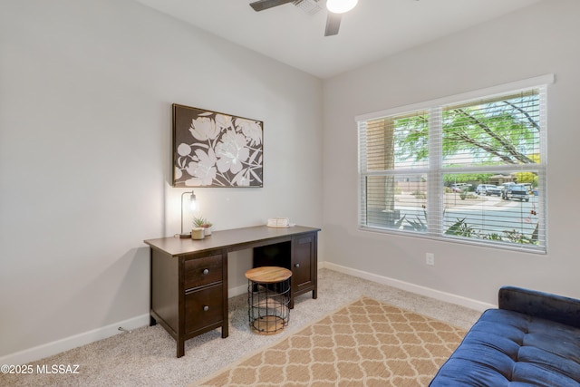 office with a ceiling fan, light carpet, and baseboards