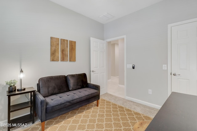 sitting room with visible vents, carpet floors, and baseboards