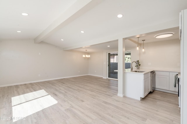 806 N Arcadia Ave, Tucson, AZ 85711 - kitchen featuring a sink, light countertops, light wood-style floors, and a chandelier