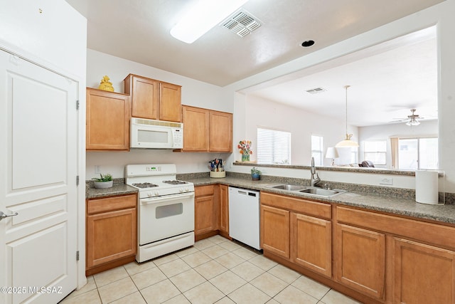 kitchen featuring visible vents, a ceiling fan, white appliances, and a sink