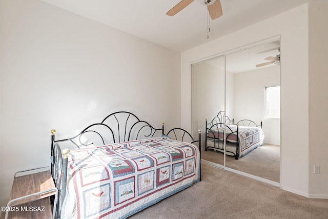 carpeted bedroom with a closet and ceiling fan