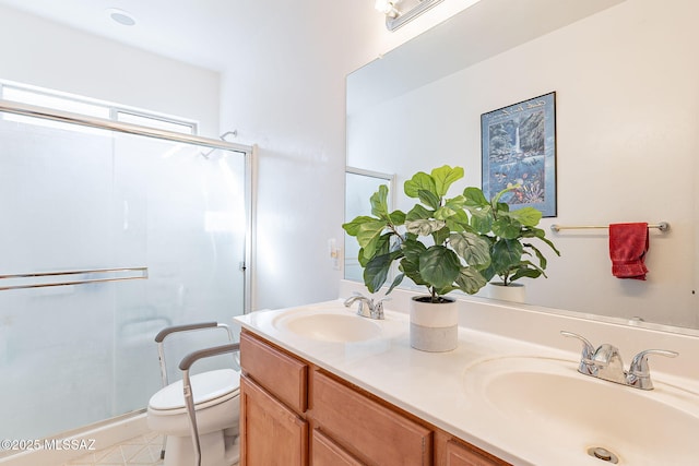 full bath with toilet, a stall shower, double vanity, and a sink