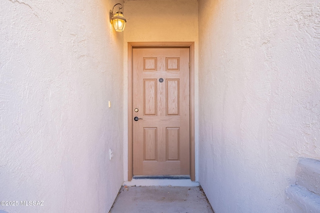 doorway to property with stucco siding