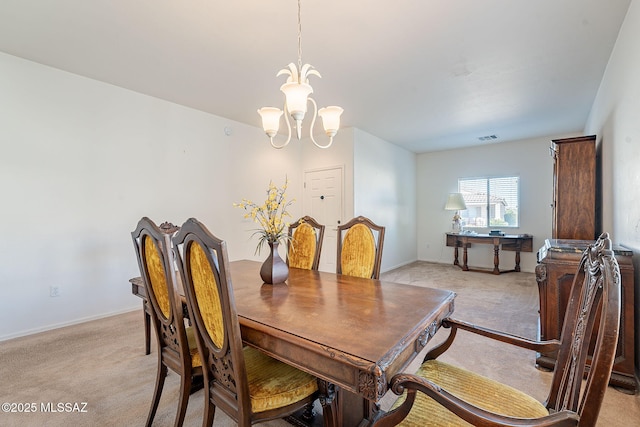 dining space featuring visible vents, a chandelier, light colored carpet, and baseboards