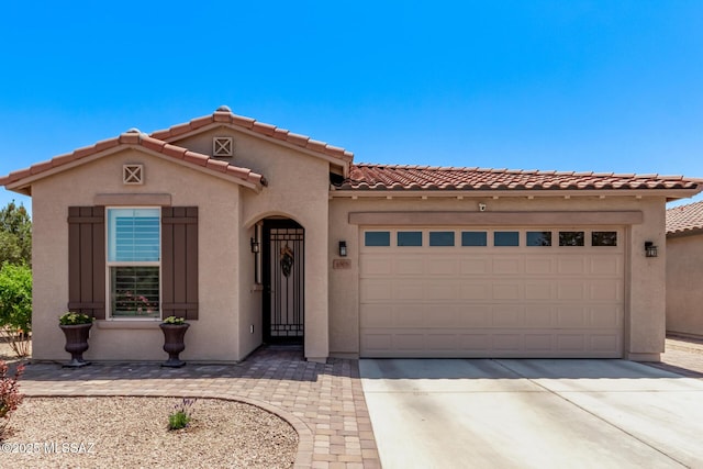 6505 W Sugar Pine Trl, Tucson, AZ 85743 - mediterranean / spanish-style home featuring stucco siding, an attached garage, concrete driveway, and a tile roof