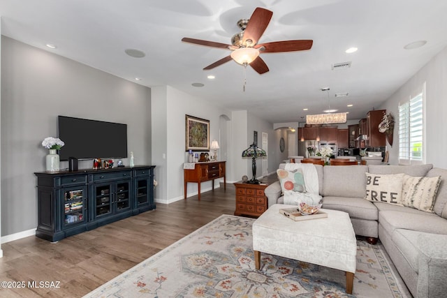 6505 W Sugar Pine Trl, Tucson, AZ 85743 - living room with ceiling fan, wood finished floors, recessed lighting, baseboards, and a chandelier