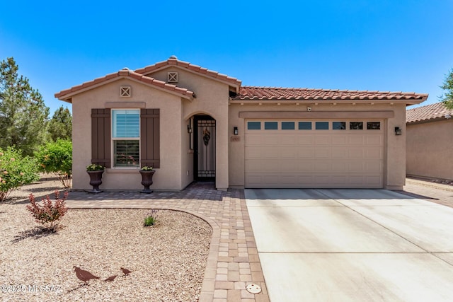 6505 W Sugar Pine Trl, Tucson, AZ 85743 - mediterranean / spanish-style home with stucco siding, an attached garage, concrete driveway, and a tiled roof