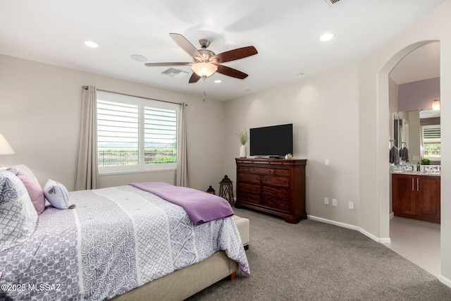 6505 W Sugar Pine Trl, Tucson, AZ 85743 - bedroom featuring light colored carpet, recessed lighting, arched walkways, ceiling fan, and ensuite bath
