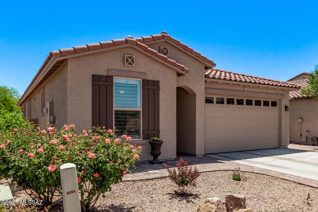 6505 W Sugar Pine Trl, Tucson, AZ 85743 - mediterranean / spanish-style house featuring a garage, stucco siding, driveway, and a tiled roof