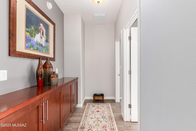 6505 W Sugar Pine Trl, Tucson, AZ 85743 - hallway featuring light wood-style flooring and baseboards