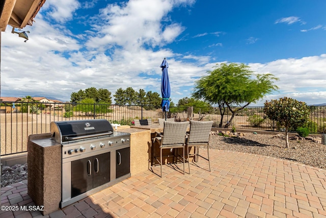 6505 W Sugar Pine Trl, Tucson, AZ 85743 - view of patio with an outdoor kitchen and a fenced backyard