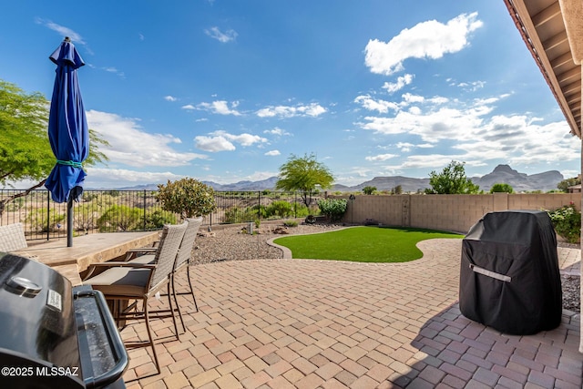 6505 W Sugar Pine Trl, Tucson, AZ 85743 - view of patio / terrace featuring a mountain view, a fenced backyard, and a grill