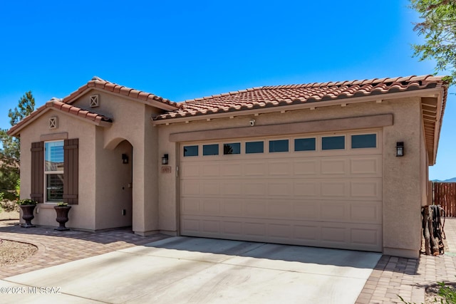 6505 W Sugar Pine Trl, Tucson, AZ 85743 - mediterranean / spanish home featuring stucco siding, an attached garage, concrete driveway, and a tiled roof