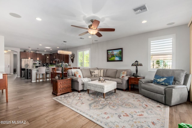 6505 W Sugar Pine Trl, Tucson, AZ 85743 - living room with ceiling fan, arched walkways, light wood-style floors, and recessed lighting