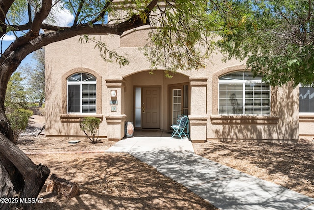 view of exterior entry featuring stucco siding