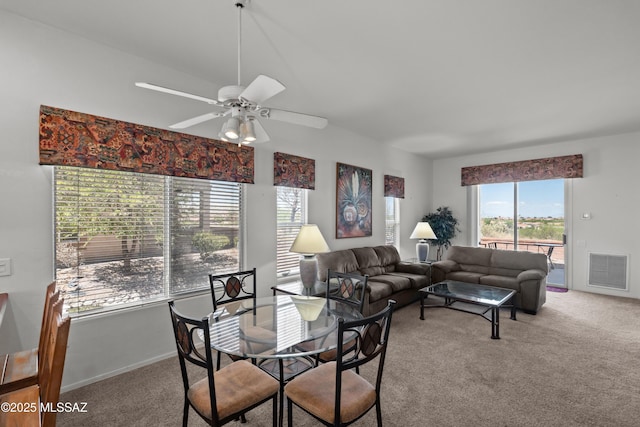 carpeted living area featuring ceiling fan, baseboards, and visible vents