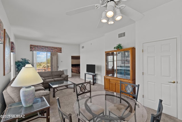 living room featuring carpet, a ceiling fan, and visible vents